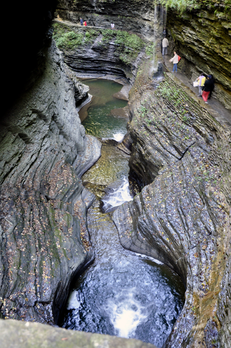 people walking under Rainbow Falls.